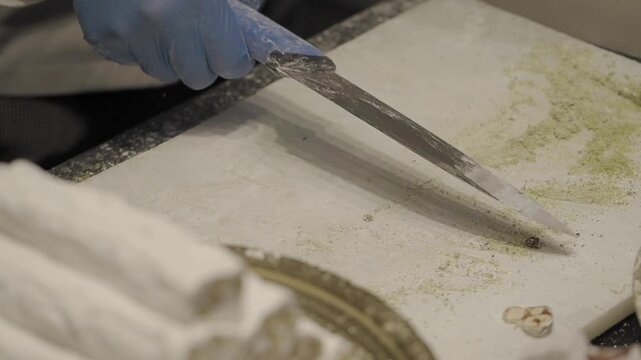A person cutting turkish delights .