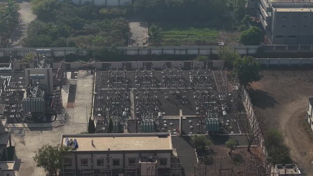 Close Aerial Shot of Power Substation Yard showing Busbars Circuit Breakers and Cooling Units.
