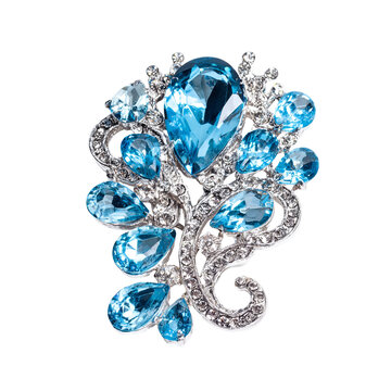 Elegant brooch with teardrop and round gemstones in a silver, floral design