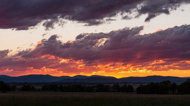 stratocumulus. Stratocumulus clouds at sunset with golden-red and purple hues, rays of light breaking through. inspiring travel planning.