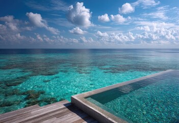 Fototapeta premium Infinity pool overlooking vibrant turquoise ocean and coral reefs