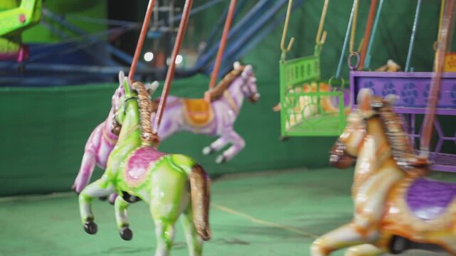 colorful carousel horse ride, fairground swing carousel motion, amusement park kids ride, carnival merry go round horses stock video.