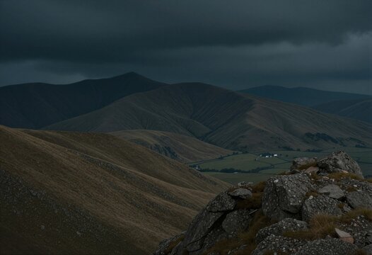 A dramatic landscape of rolling hills and distant mountains under a stormy sky.