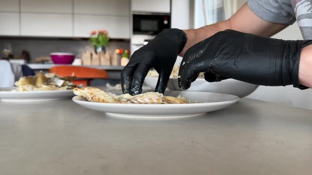 Midsection of man cleaning the bones of cooked cod