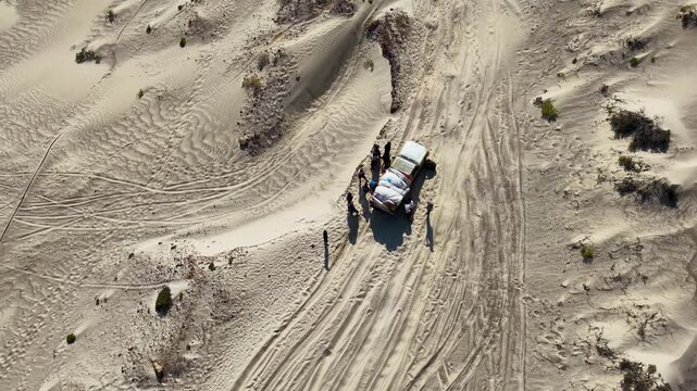 Aerial Desert Off-Road stuck Vehicle With Group on Sandy Tracks. Sokotra, Yemen.
