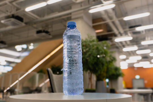 Chilled Unbranded Plastic Water Bottle with Condensation in a Modern Co-working Space