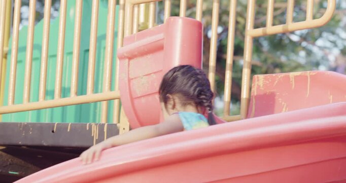 Little kindergarten girl enjoy climb on slider outdoor playground city park active learnning