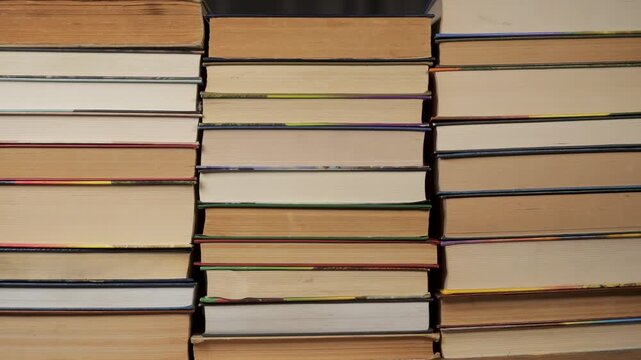 Bookcases Create stop motion, horizontal hardcover bookcases with visible page edges, several books laid flat, visible paper blocks, symmetrical arrangement