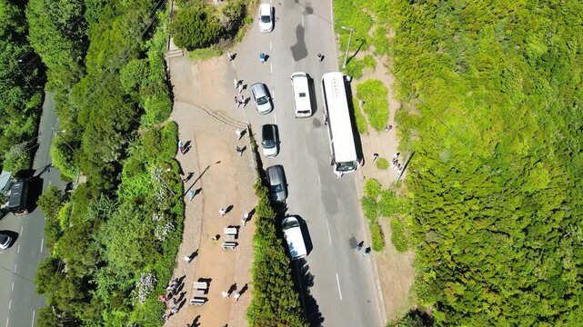 Stunning bird's eye perspective of Encumeada mountain pass showcasing lush green slopes and Atlantic horizon in Madeira Portugal