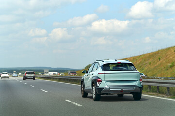 Fototapeta premium Compact SUV road trip through rural landscape