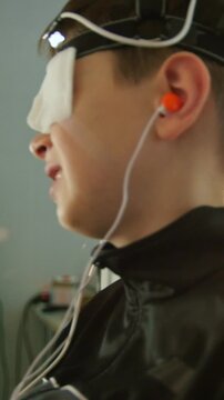 Boy with electrodes on the head looking to monitor - healthcare children's diagnostic - Ophthalmology researching