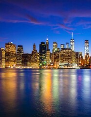Fototapeta premium A blurred city skyline at dusk with vibrant lights reflected on water