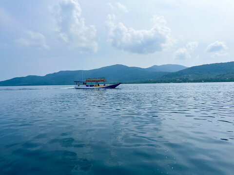 Karimun Jawa, Indonesia: Traditional Wooden Boat Floating on Crystal Clear Tropical Sea, Scenic Ocean View with Calm Water for Travel Tourism, Marine Adventure, and Relaxing Island Vacation