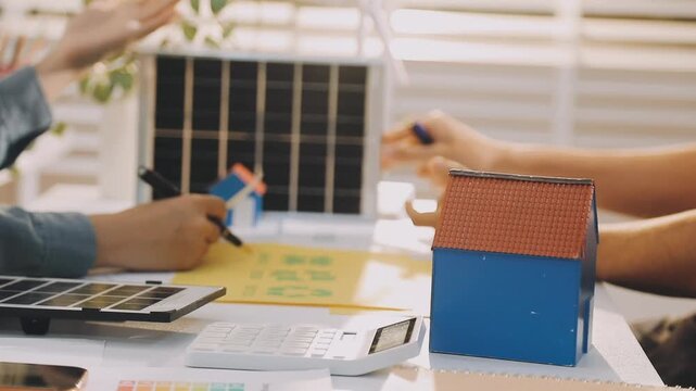 Business executives collaborating on environmental sustainability strategy utilizing renewable energy solutions to achieve net zero targets in corporate meeting.