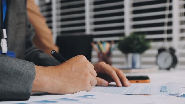 Asian business adviser meeting to analyze and discuss the situation on the financial report in the meeting room.Investment Consultant, Financial advisor and accounting concept