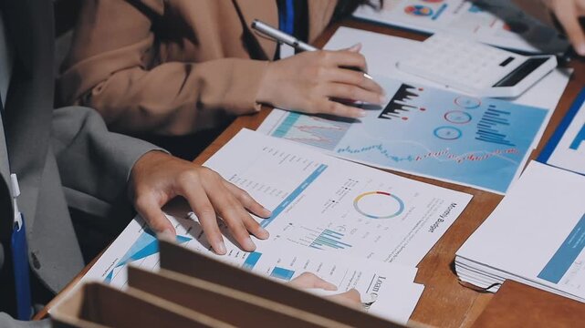 Asian business adviser meeting to analyze and discuss the situation on the financial report in the meeting room.Investment Consultant, Financial advisor and accounting concept