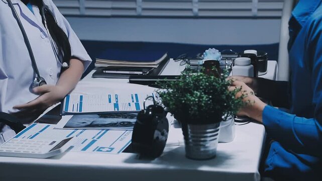 Professional physician working together at hospital, Latino woman doctor discussing with senior doctor for solution to treat patient in workroom.