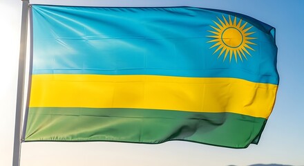 Fototapeta premium Rwanda national flag waving in sunlight against clear blue sky