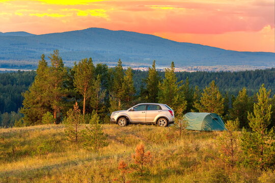parking of autotourists at a gorgeous dawn in the Ural mountains on a summer day
