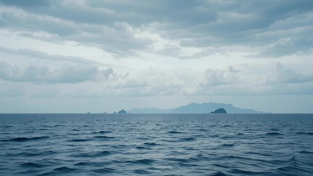 ocean horizon with distant islands under cloudy sky over open sea