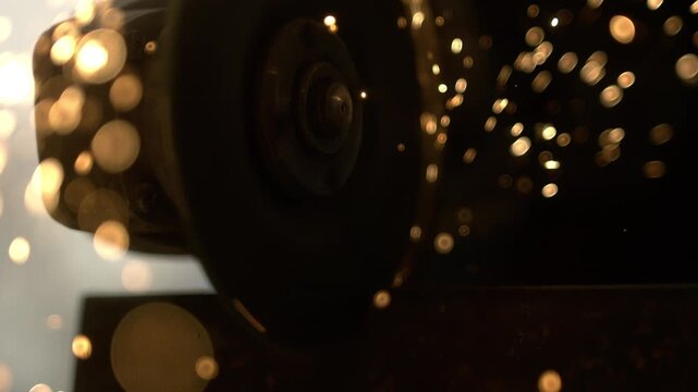 A worker uses a grinding tool as sparks fly in the air. The bright light from the sparks stands out against the backdrop of a sunset. The moment captures the activity and surroundings.