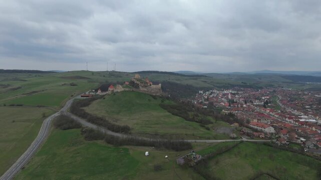Aerial cinematic approach to Rupea citadel over village