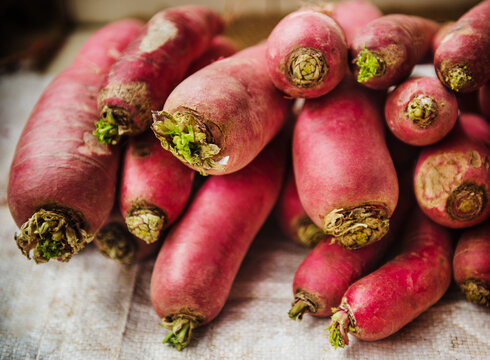 red daikon radishes, a winter radish variety known for its bright pink to red exterior and crispy texture. 