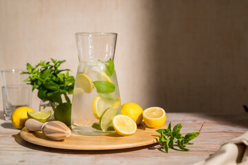 Fototapeta premium Lemonade with lemons, limes and fresh mint. Homemade lemonade summer drink
