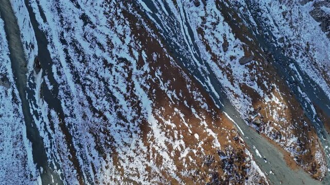 Textured Alpine Terrain with Melting Snow