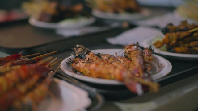 Close view of grilled shrimp satay at Asian street food market, traditional seafood dish and culinary travel
