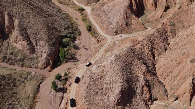 Offroad Jeeps Driving through Canyon Kyrgyzstan Drone view