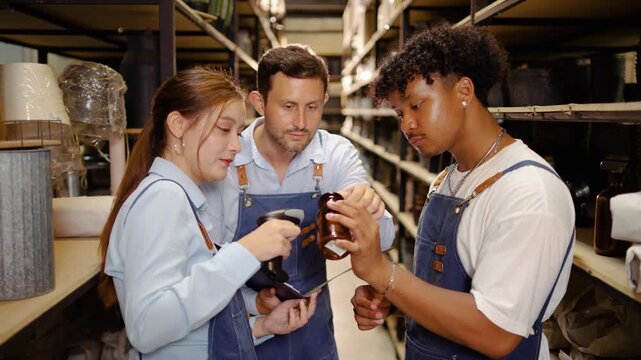 Diverse small business team using a barcode scanner for inventory management in a warehouse, checking products for quality control. Ideal for logistics, supply chain, and retail operations themes.