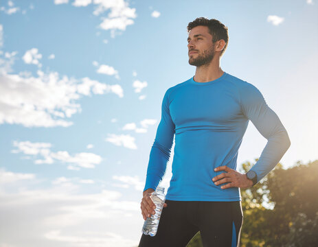 Man in blue shirt exercising outdoors.