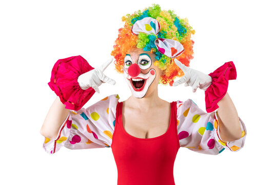 Funny female clown, woman entertainer dressed as a colorful Joker in a suit and wig, with clown whiteface makeup