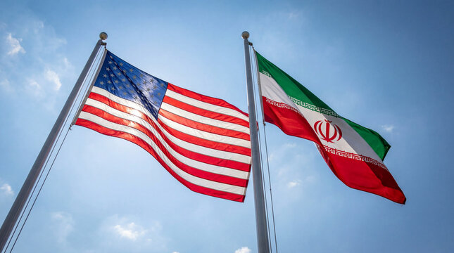 American and Iranian flags waving together against a clear blue sky