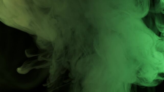 Thick plume of smoke rises and swirls against a black background. Dynamic lighting changes its color from blue to purple and green, creating an ethereal texture.