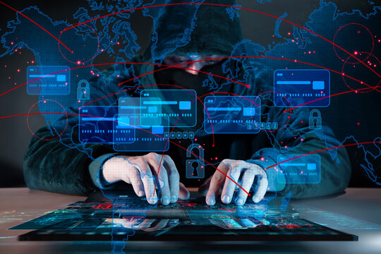 Hooded cybercriminal behind laptop with card data dashboards, lock icons and global connection lines overlay, representing financial fraud, hacking and digital theft.
