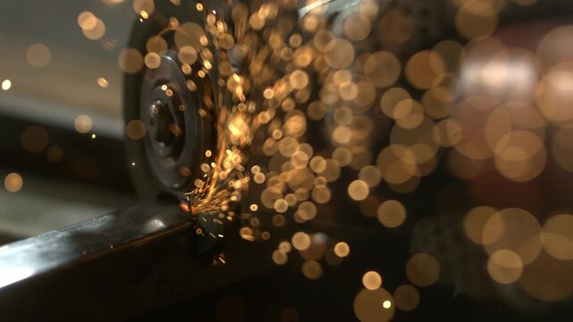 Metal is being ground, creating sparks that fly in multiple directions. The process shows close-up details of the metal, the tool, and the flying sparks in a workshop setting.