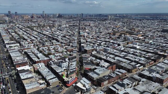 Southward grid expanse near S 13th St and Shunk St shows long residential corridors stretching toward riverfront edge. Flat roofs, muted tones, soft atmospheric diffusion define Philadelphia, PA