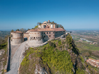 Fototapeta premium Aerial drone view of Torriana Two Towers Castle, Emilia-Romagna, Italy – dramatic hilltop fortress with medieval ruins and panoramic countryside landscape