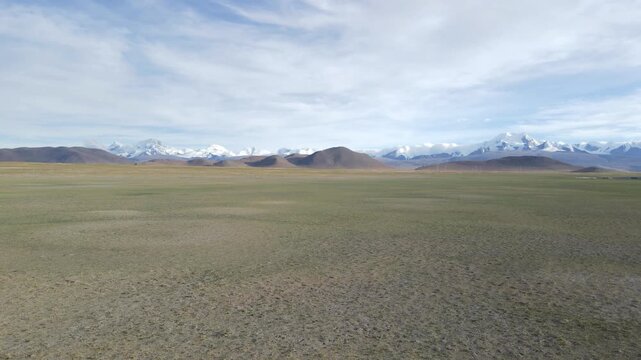 Cinematic Forward Push Over Dry Plateau Toward Distant Snow Mountains, Tibet China