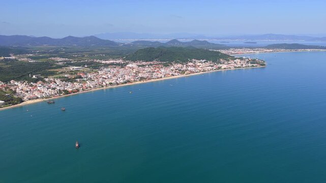 Aerial view of Canavieiras and Jurere beaches with calm blue sea and green hills, Florianopolis, Santa Catarina.