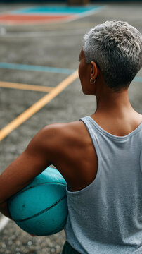 Back view of athletic person on court, conveying focus, readiness, discipline, movement, strength, quiet determination, training energy, and control.