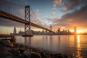 Obraz premium San Francisco Bay Bridge at Sunrise with City Skyline Reflection.
