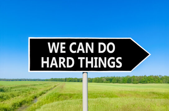 Support, help we can do hard things symbol. Concept words We can do hard things on beautiful black road sign. Beautiful blue sky field background. Business we can do hard things concept. Copy space.