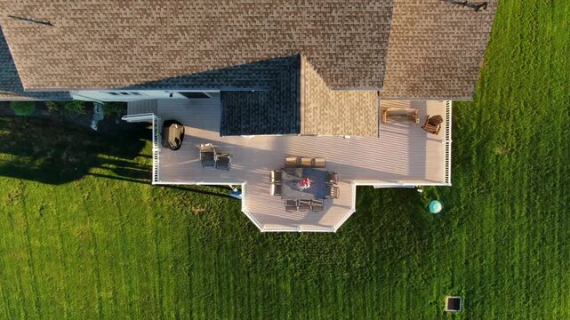 Aerial top down vieaw of luxury backyard deck and patio area on a sunny summer day