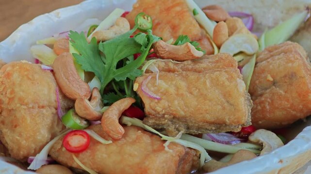 Deep Fried Sea Bass with Seasoning Fish Sauce and Green Mango Salad.