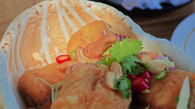 Deep Fried Sea Bass with Seasoning Fish Sauce and Green Mango Salad.