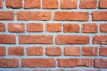 Obraz premium Texture of old red brick wall background with grey cement joints.
