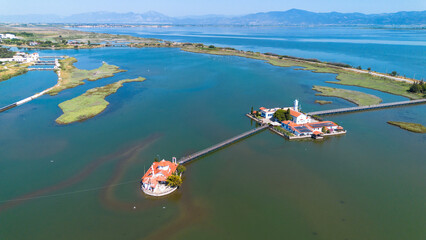 Obraz premium Aerial view of the Monastery of Agios Nikolaos on Vistonida Lake with wooden bridges, Xanthi, Greece.